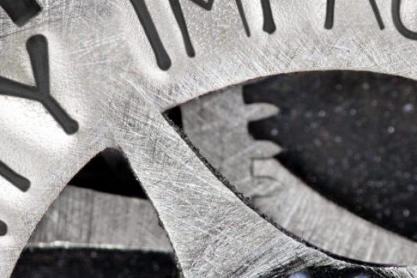 Macro photo of tooth wheel mechanism with QUALITY IMPROVEMENT concept related words imprinted on metal surface